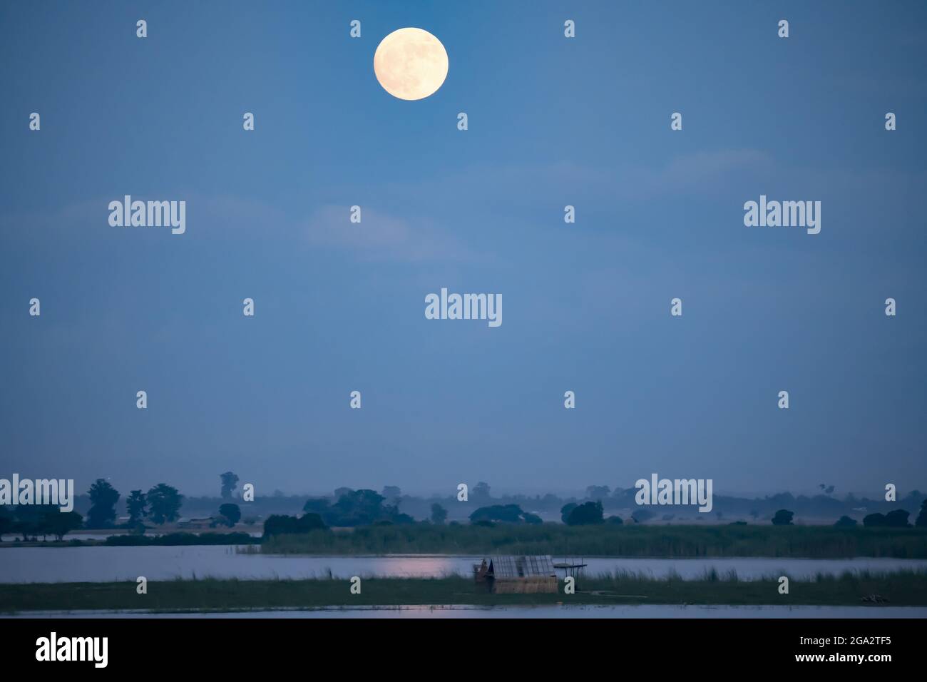 Full moon rising over the Ayeyarwady (Irrawaddy) River; Rural Jungle, Kachin, Myanmar (Burma) Stock Photo