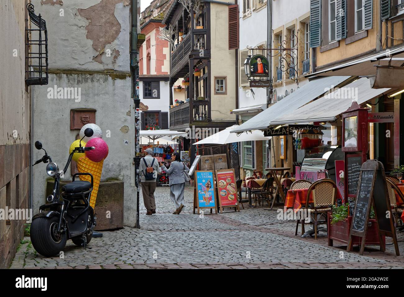 STRASBOURG, FRANCE, June 23, 2021 : Restaurant terraces in a small street of Strasbourg touristic center. Stock Photo