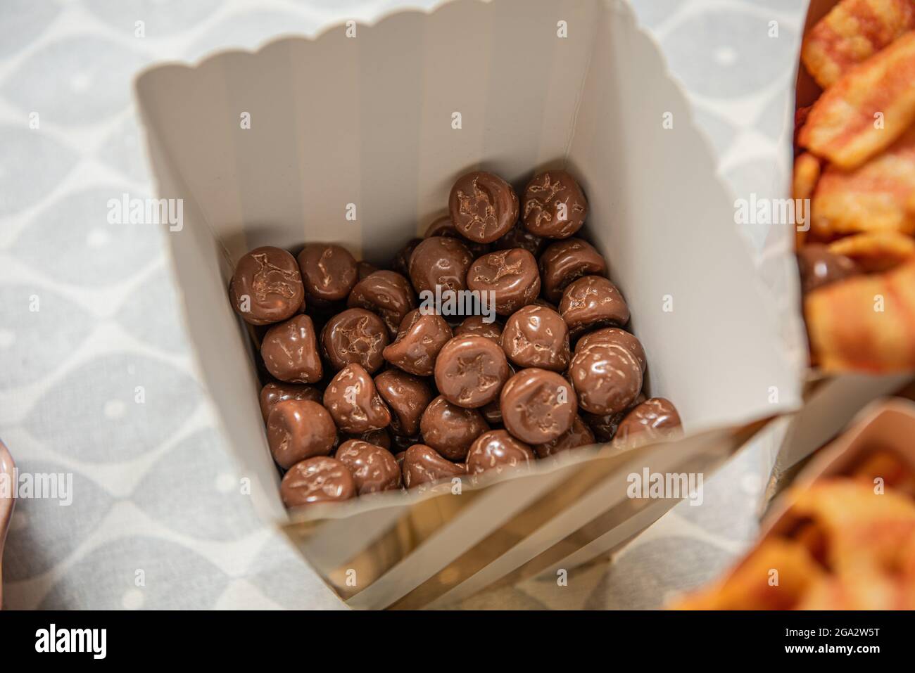 Chocolate snacks in a paper cup Stock Photo - Alamy
