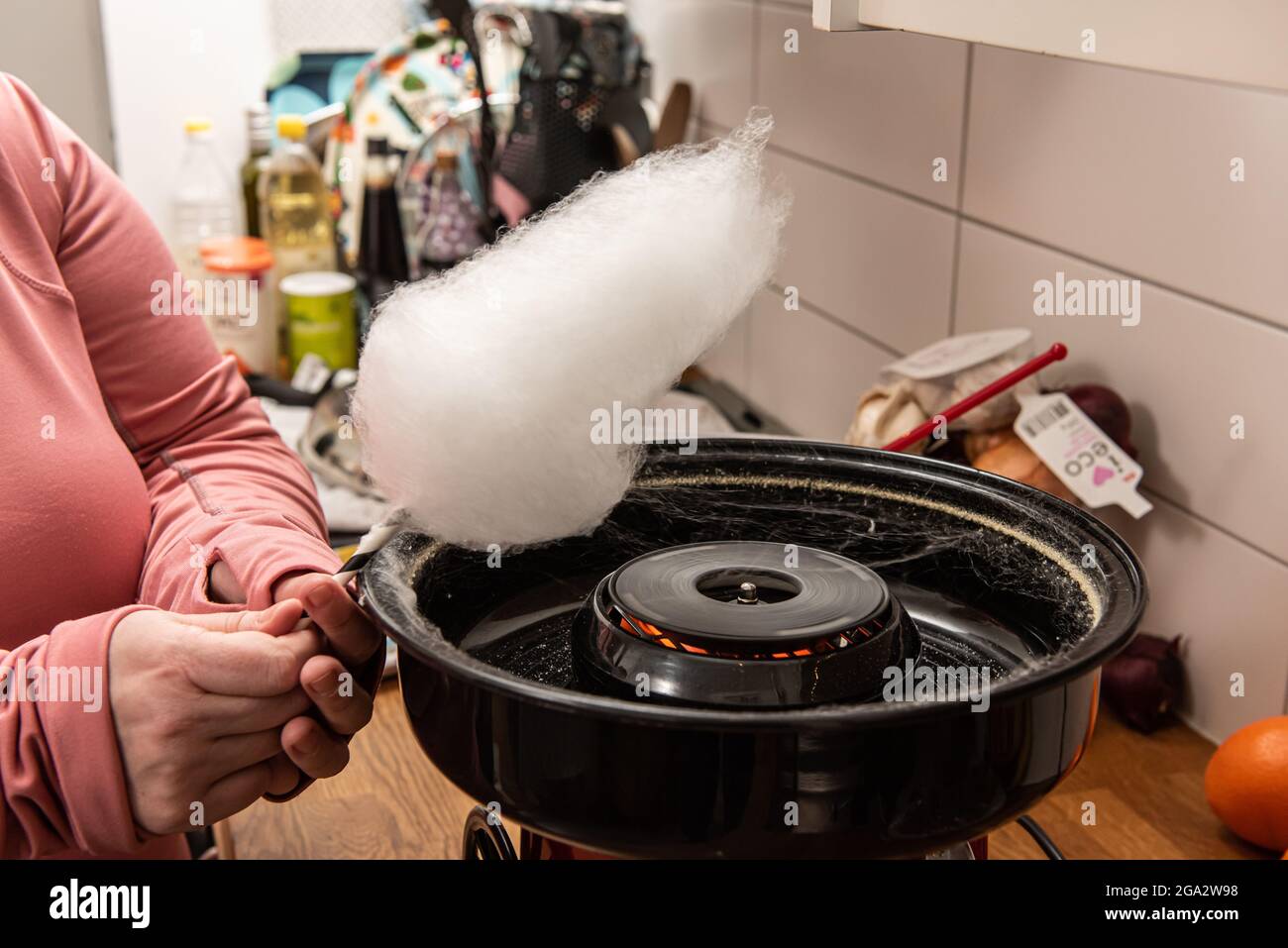 Operating a cotton candy machine Stock Photo Alamy