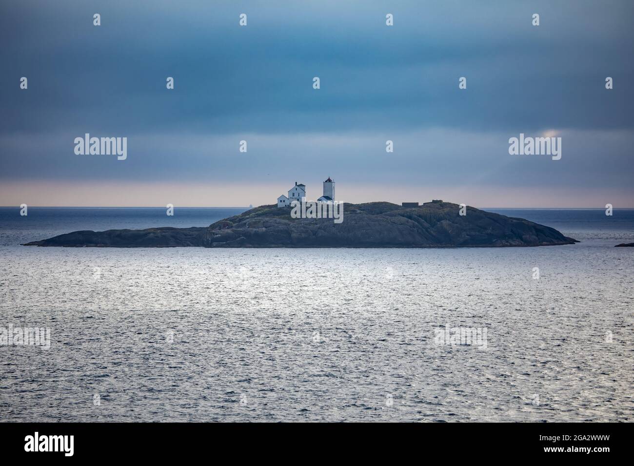 Terningen Lighthouse at twilight on a remote island in the Municipality of Hitra near the mouth of the Hemnfjorden in the Western Fjords of Norway Stock Photo