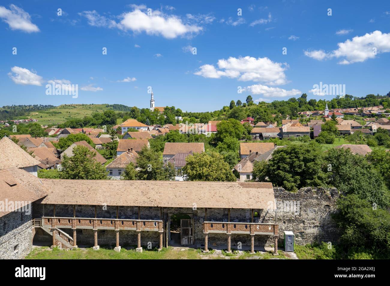 View of the town and the Cetatea Bethlen Medieval Castle of Racos on a sunny day; Racos, Transylvania, Romania Stock Photo