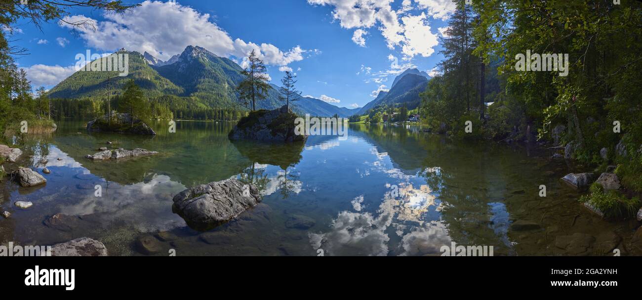 Norway spruce (Picea abies) tree on a small, rock island in the clear waters of Lake Hintersee in the Bavarian Alps Stock Photo