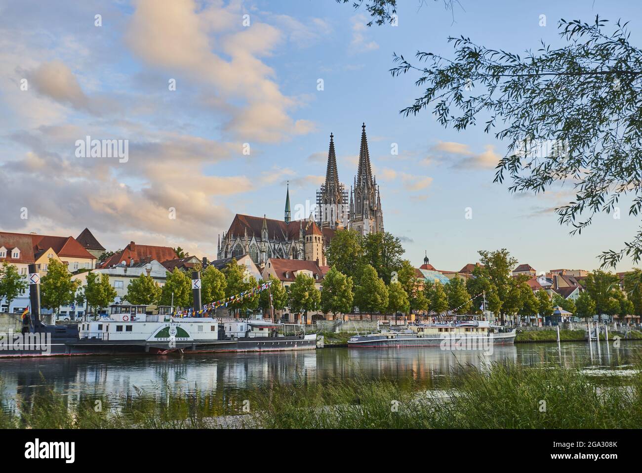 Outlook over the Danube River with the Gothic St Peter's Cathedral from the Marc-Aurel-shore in the Old Town of Regensburg with historical steambo... Stock Photo