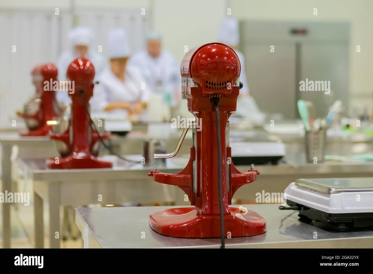 Pro Chef Using Mixer Professional chef workplace with modern food mixers at cuisine of ...