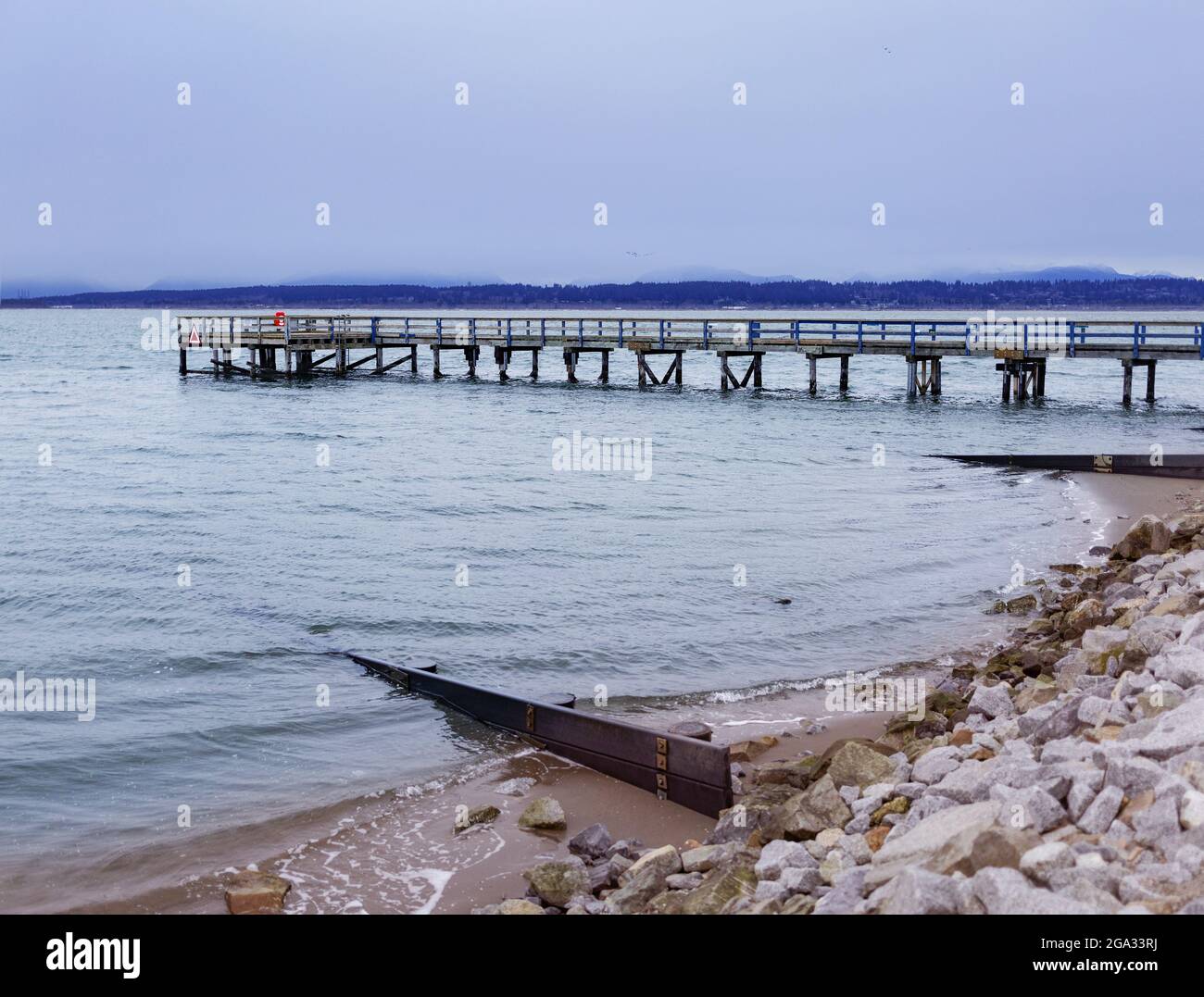 Pier reaching out in the water off Crescent Beach; Surrey, British Columbia, Canada Stock Photo