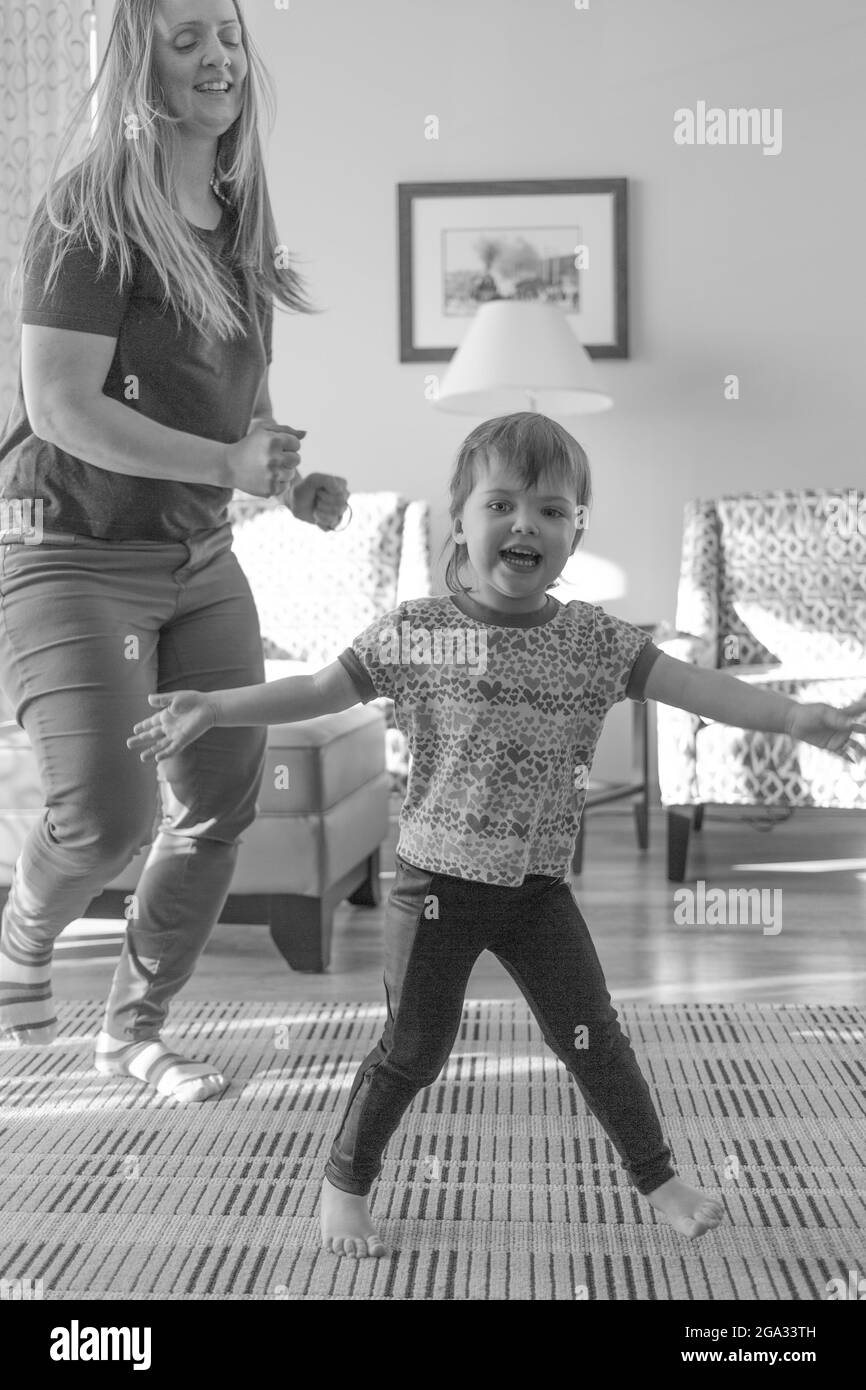 A mother and daughter having a dance party together; White Rock, British Columbia, Canada Stock Photo