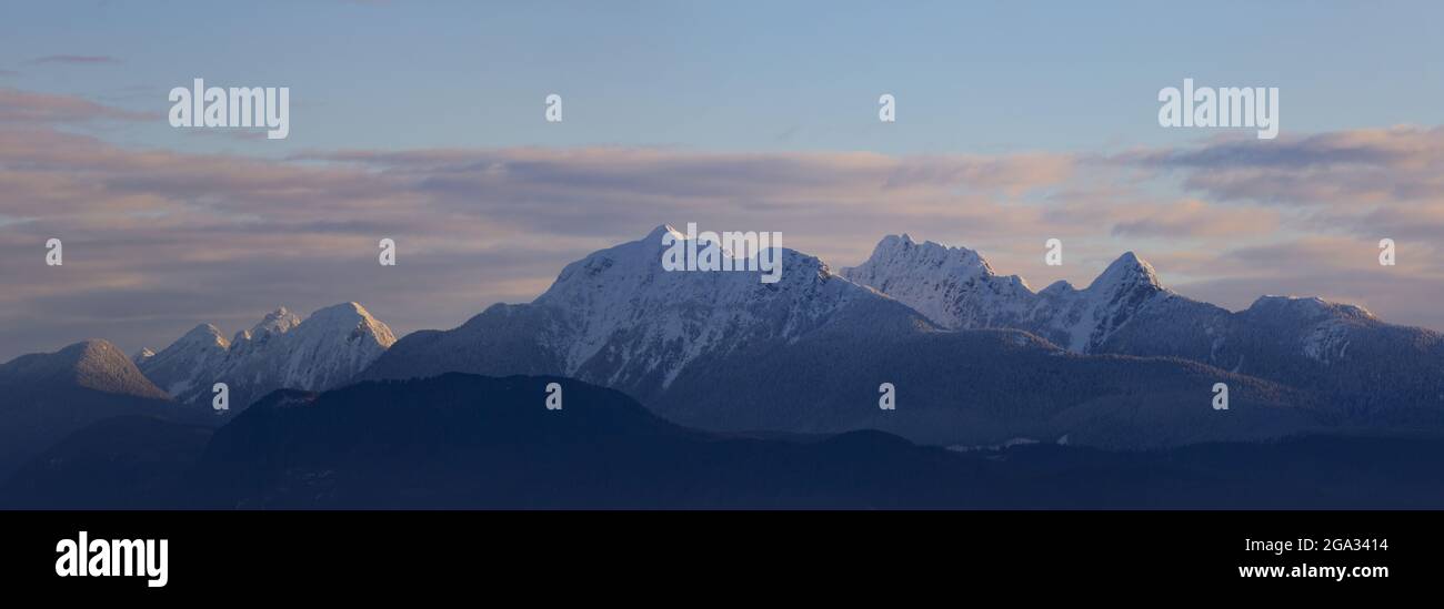 Golden Ears mountain peaks with a sunset glow as viewed from Surrey, BC; British Columbia, Canada Stock Photo