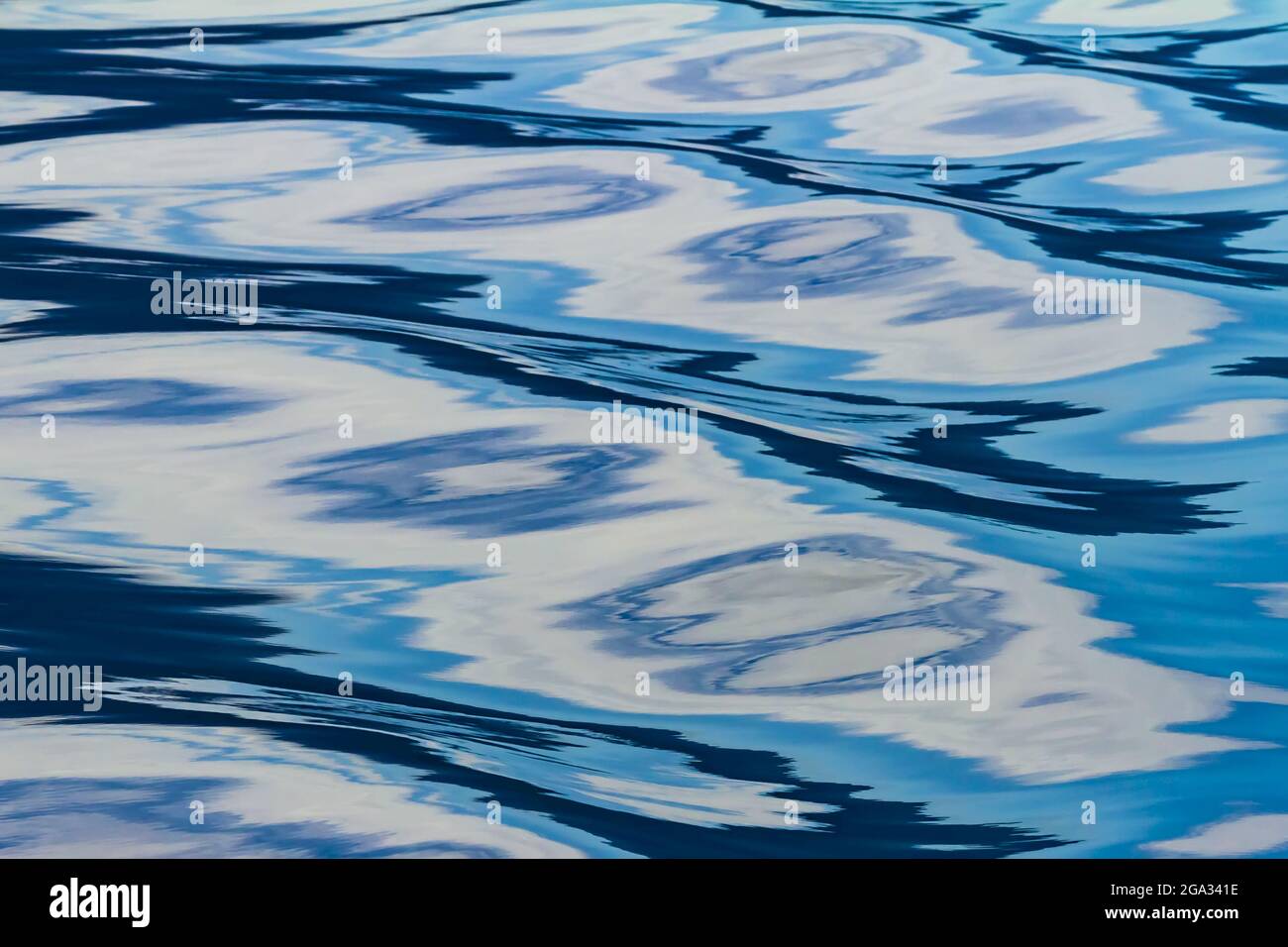 Reflections on the surface of water creating a pattern in tones of blue, Inside Passage, Great Bear Rainforest; British Columbia, Canada Stock Photo