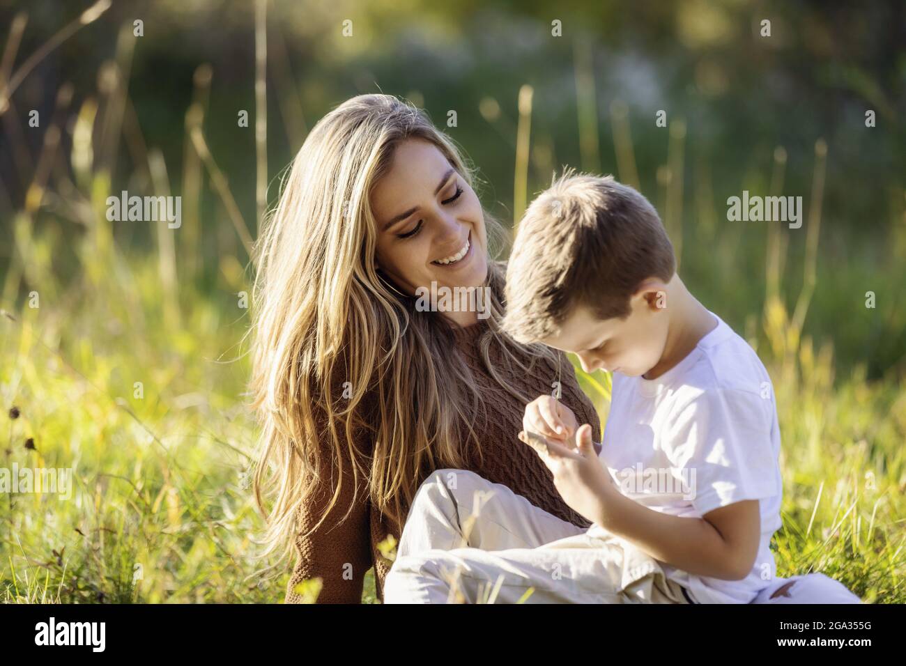 A mother spending quality time with her young son, outdoors in a city park; Edmonton, Alberta, Canada Stock Photo