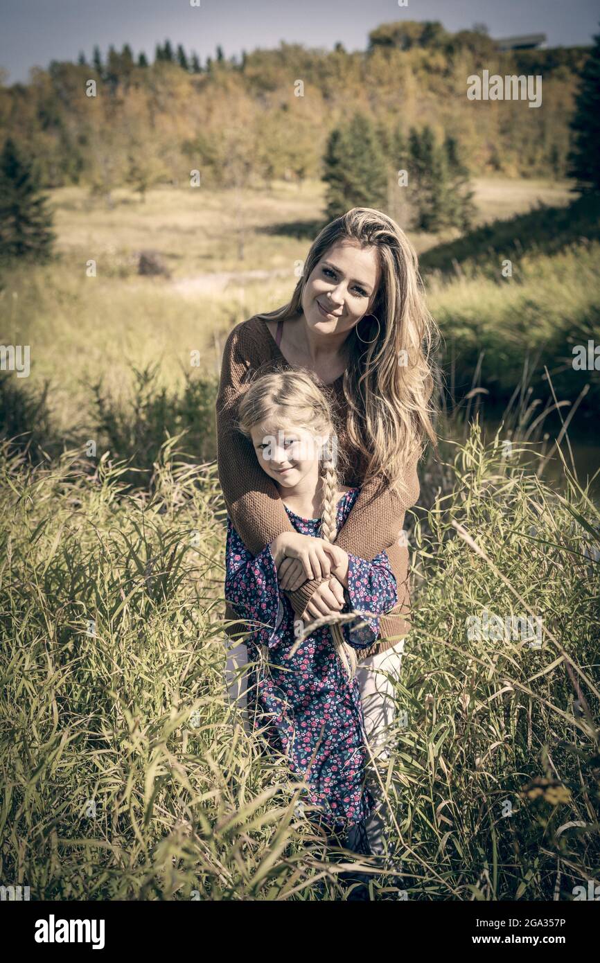 A mother spending quality time outdoors with her daughter in a city park; Edmonton, Alberta, Canada Stock Photo