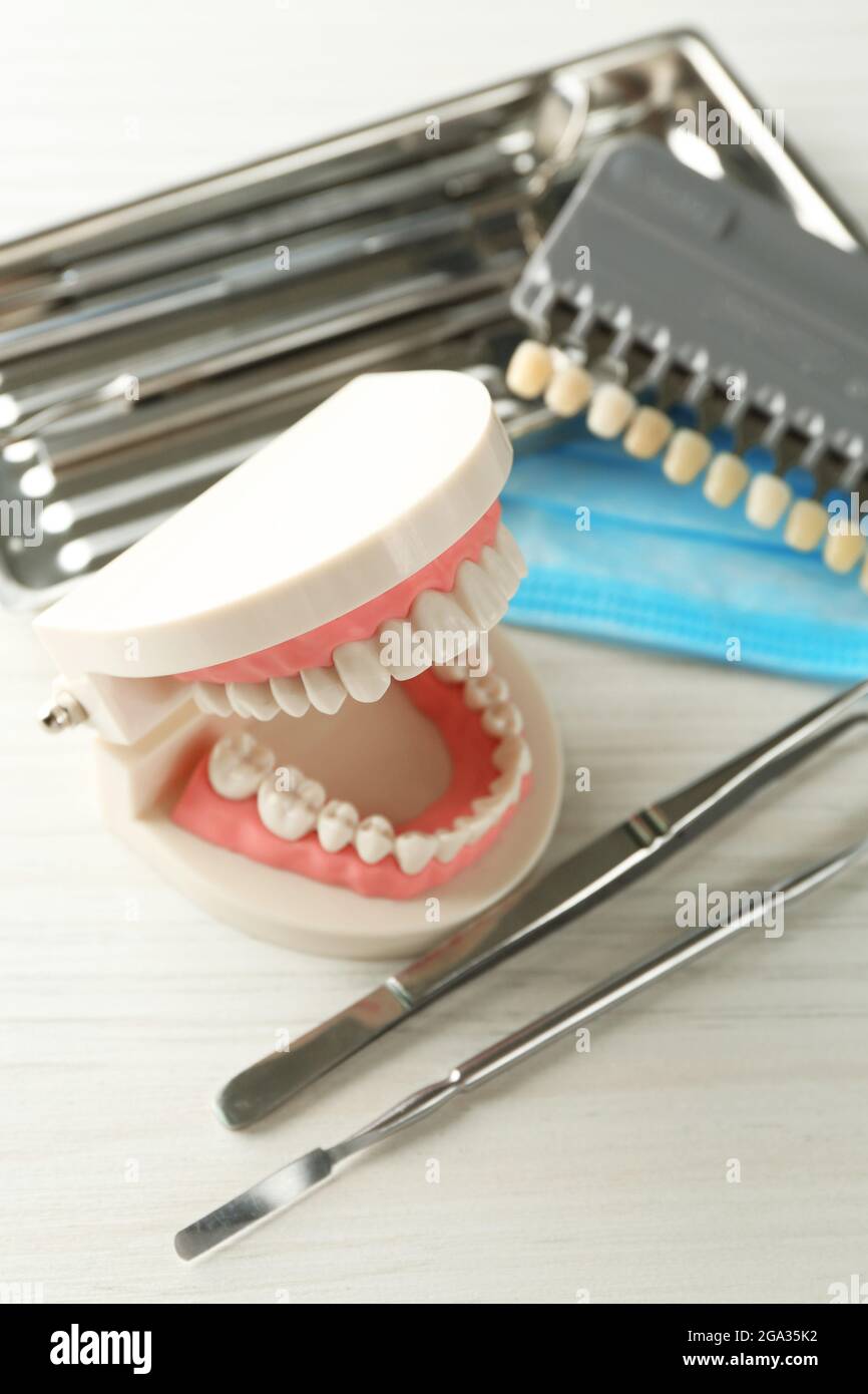 Or Instruments With Teeth White teeth and dental instruments on table background Stock Photo - Alamy