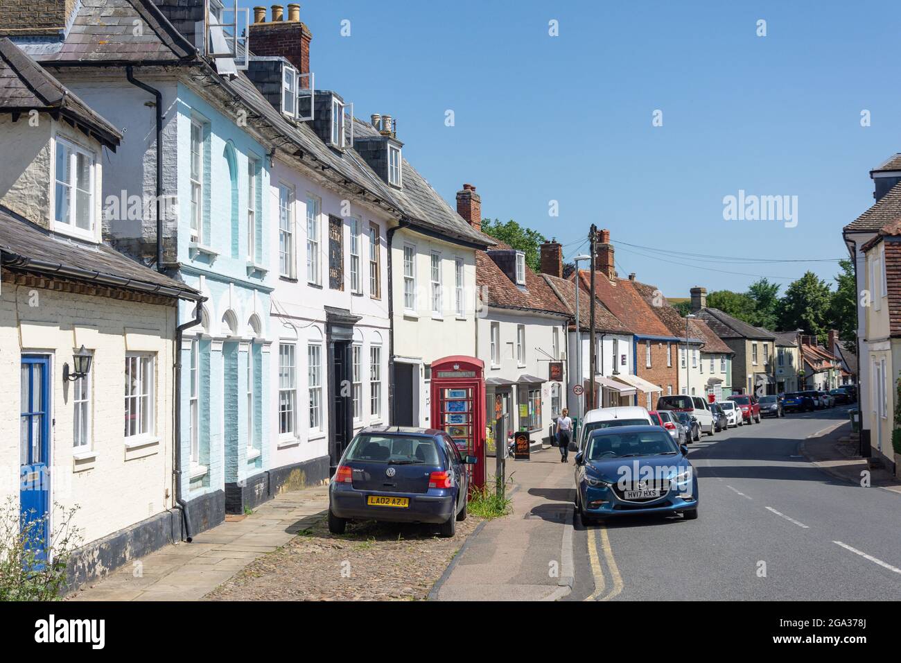 Period houses high street cars parked shops shopping stores lint hires
