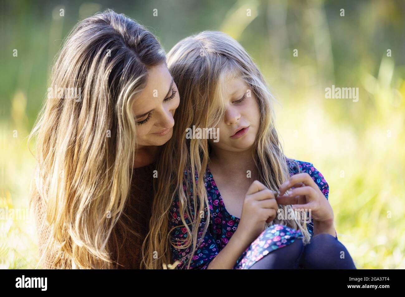 A mother spending quality time outdoors with her daughter in a city park; Edmonton, Alberta, Canada Stock Photo