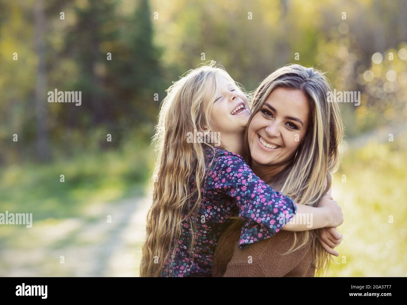 Portrait of a mother with her young daughter, outdoors in a city park; Edmonton, Alberta, Canada Stock Photo