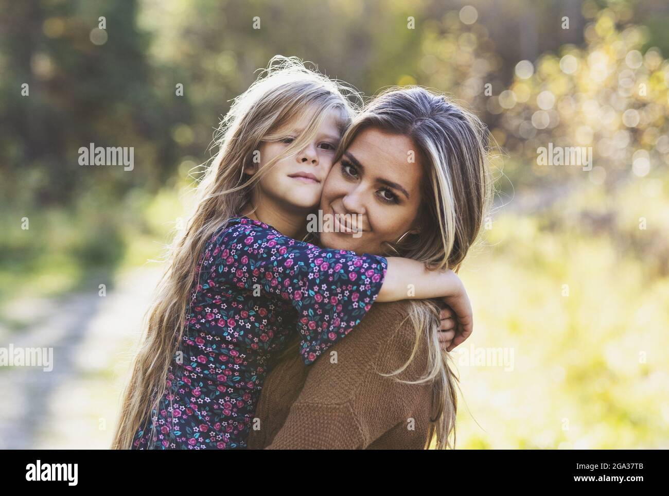 Portrait of a mother with her young daughter, outdoors in a city park; Edmonton, Alberta, Canada Stock Photo