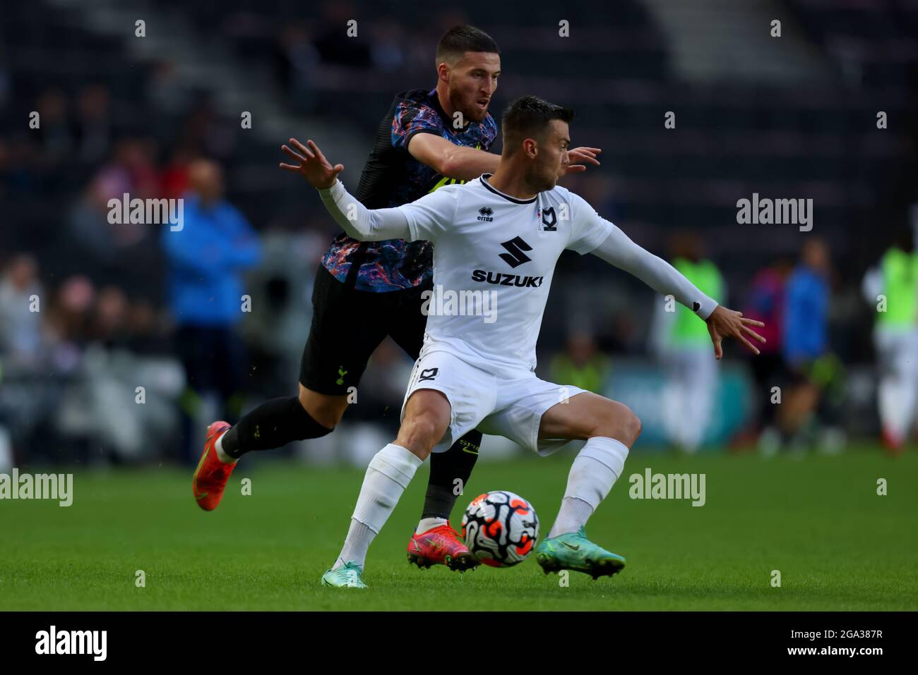 28th July 2021; Stadium MK, Milton Keynes, Buckinghamshire, England; Pre Season Friendly Football, Milton Keynes Dons versus Tottenham Hotspur; Matt Doherty of Tottenham Hotspur competes for the ball with Scott Twine of MK Dons Stock Photo