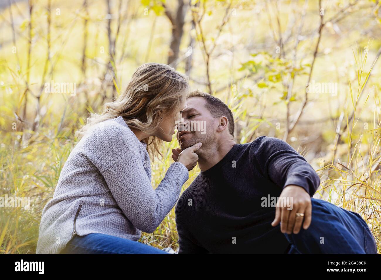 A mature married couple spending quality time together in a city park during the fall season; St. Albert, Alberta, Canada Stock Photo