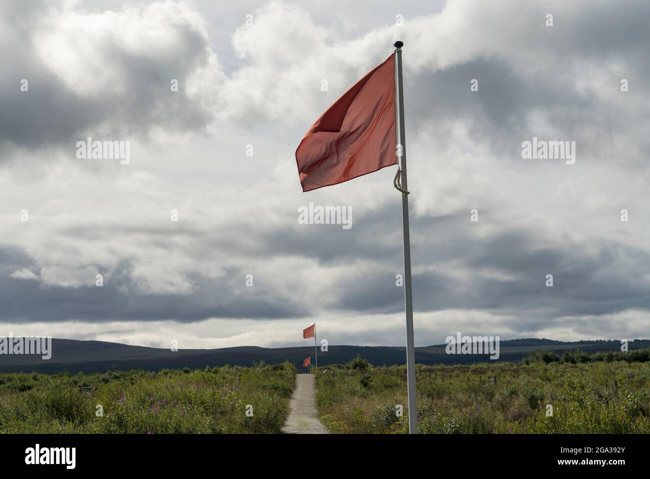Red flags, indicating the historical line of government troops, fly at Culloden Battlefield near Inverness, Scotland; Inverness, Scotland Stock Photo