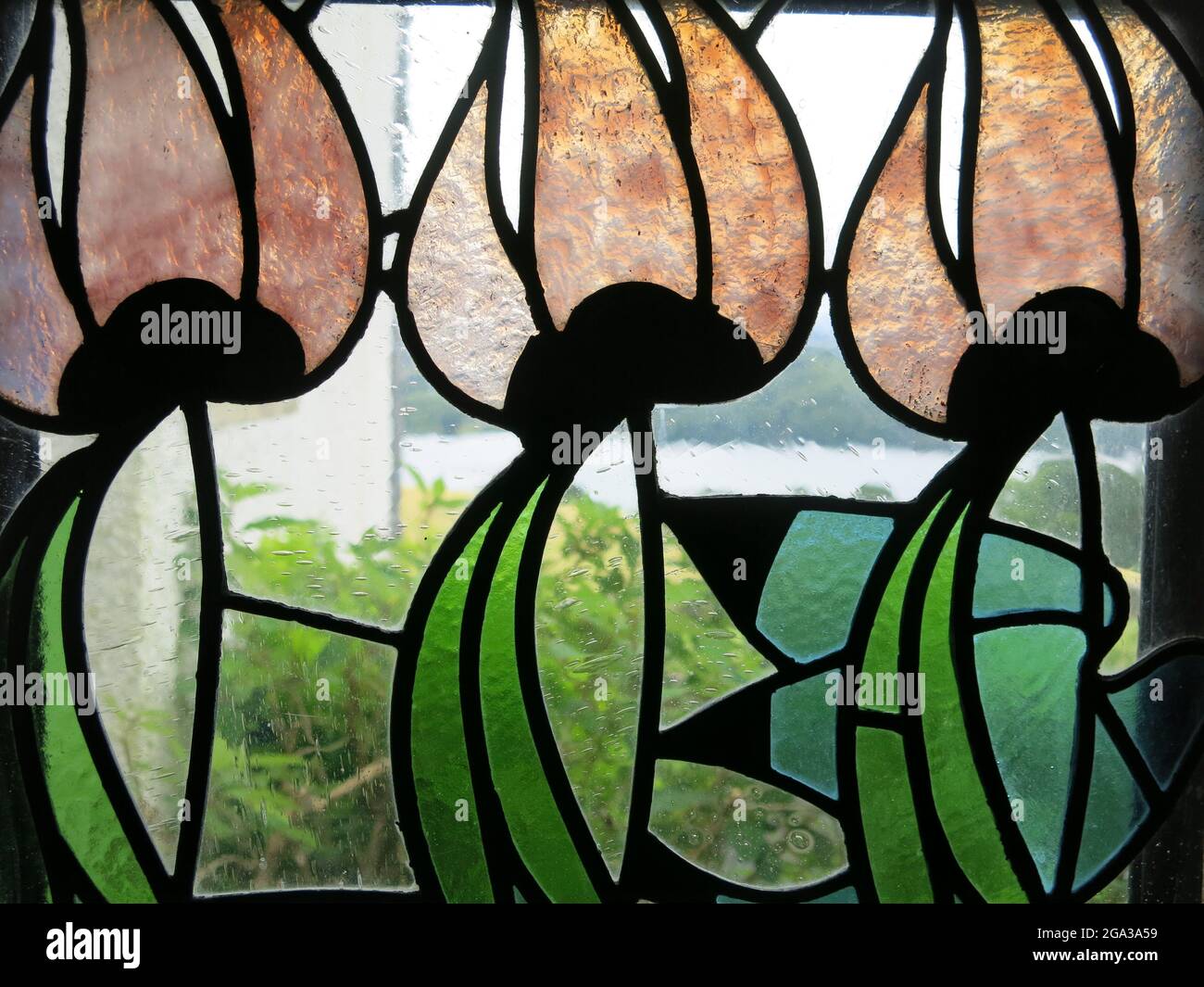 Stylised flowers in a decorative stained glass window at Blackwell