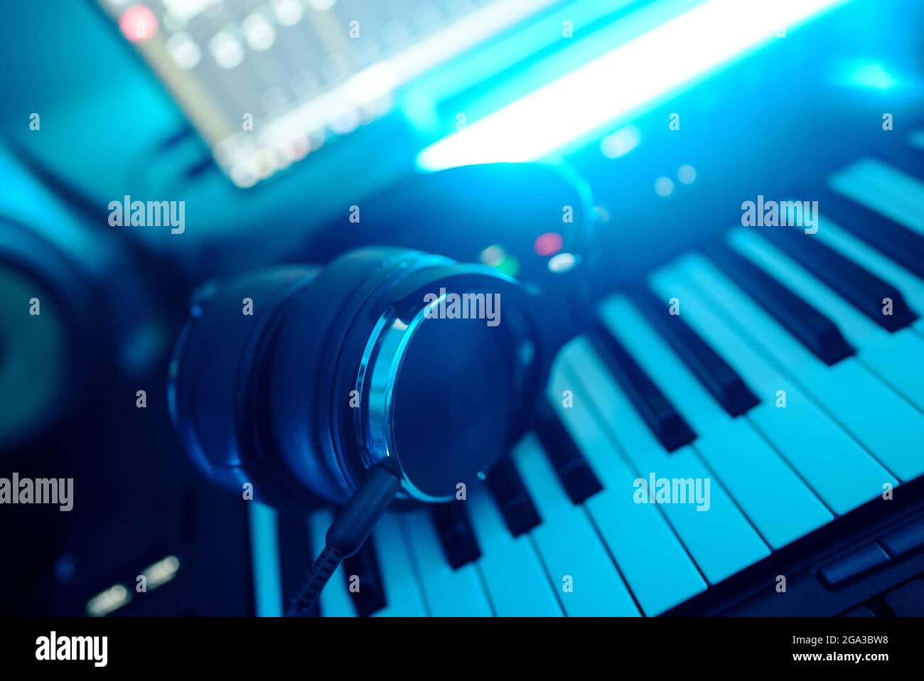 Headphones on the piano keyboard. Recording studio concept Stock Photo