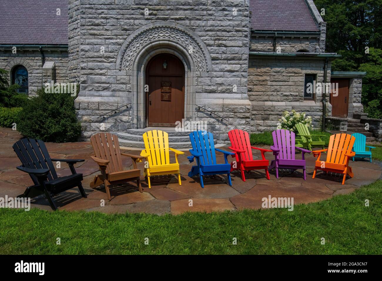 Colorful Adirondack chairs at St. Paul's Episcopal church in Stockbridge, MA Stock Photo
