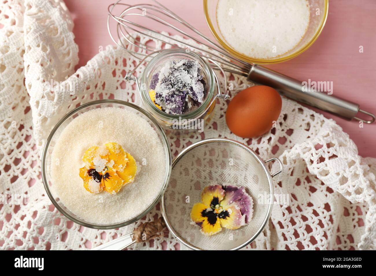 Making candied violet flowers with egg whites and sugar, on color
