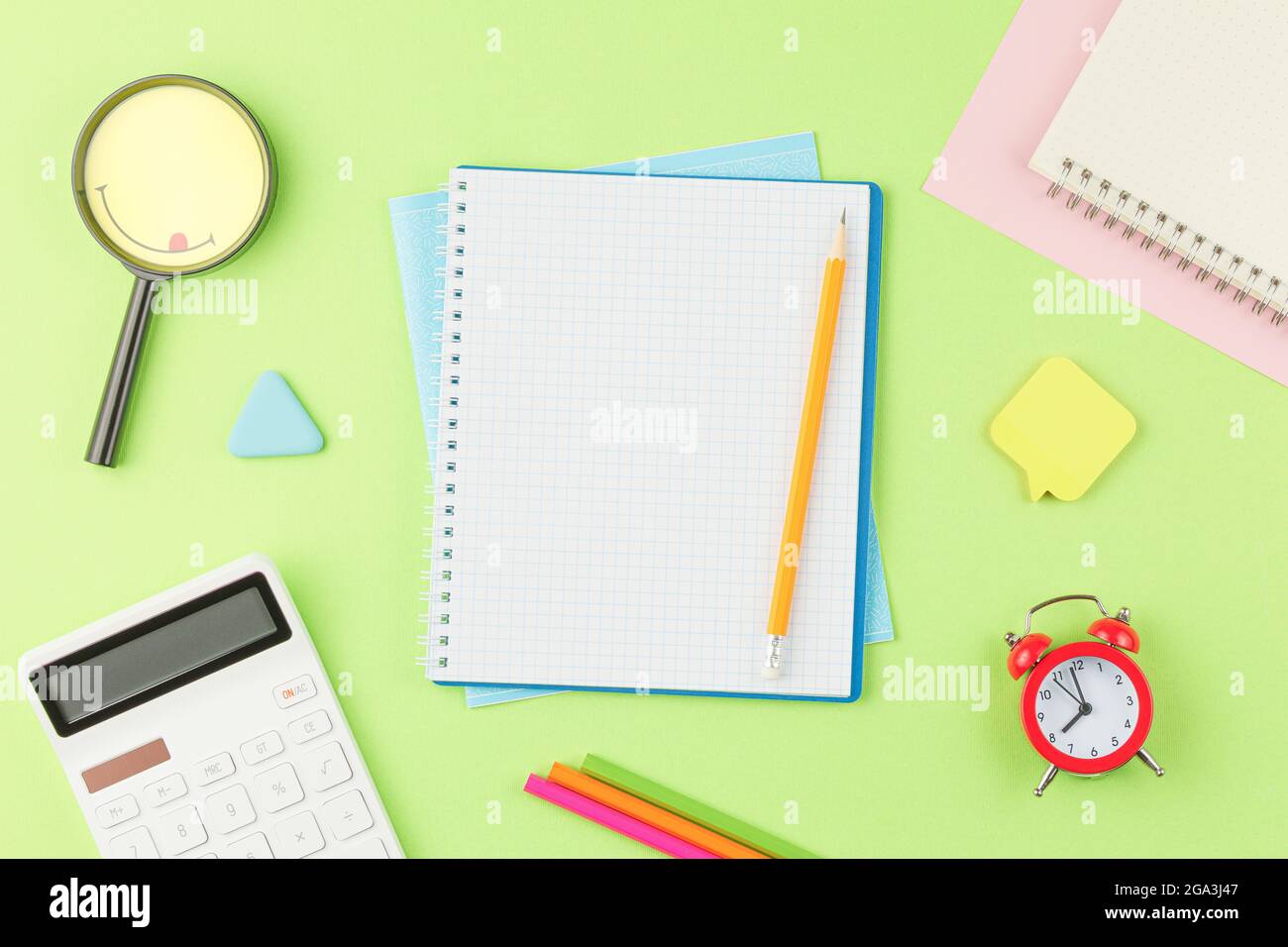 Open spiral notebook with school supplies. Stock Photo