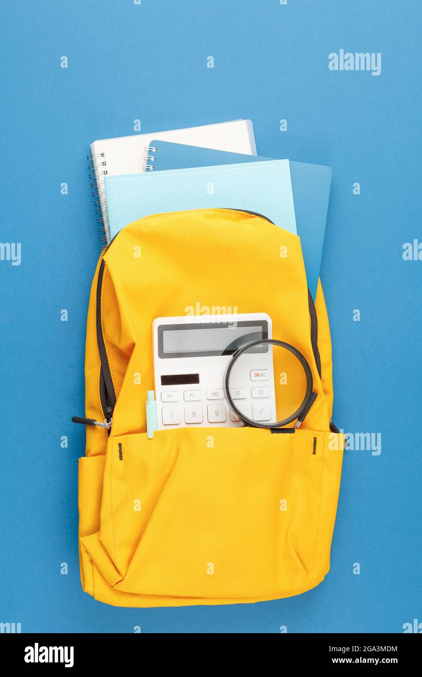 School backpack with stationery on the desk. Stock Photo