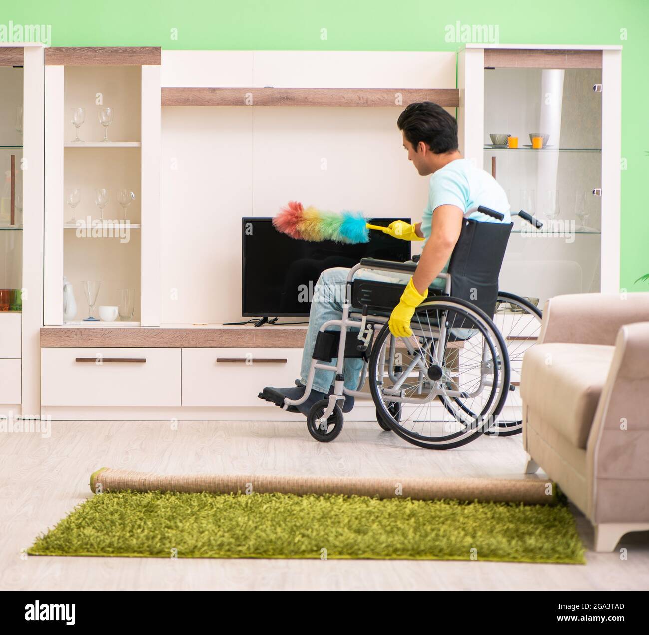 The disabled man on wheelchair cleaning house Stock Photo Alamy