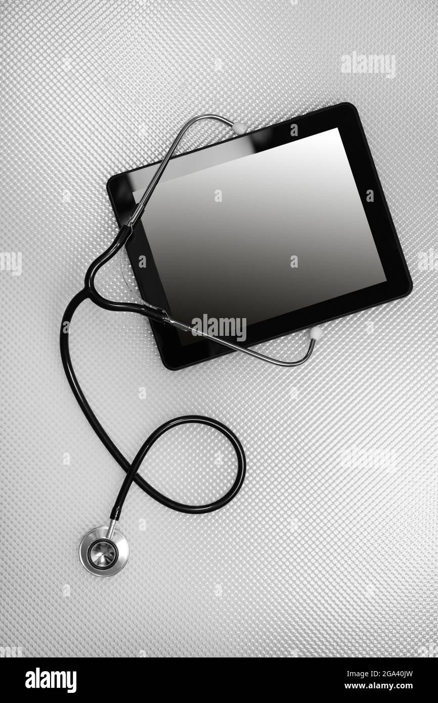 Medical tablet with stethoscope on white background Stock Photo - Alamy