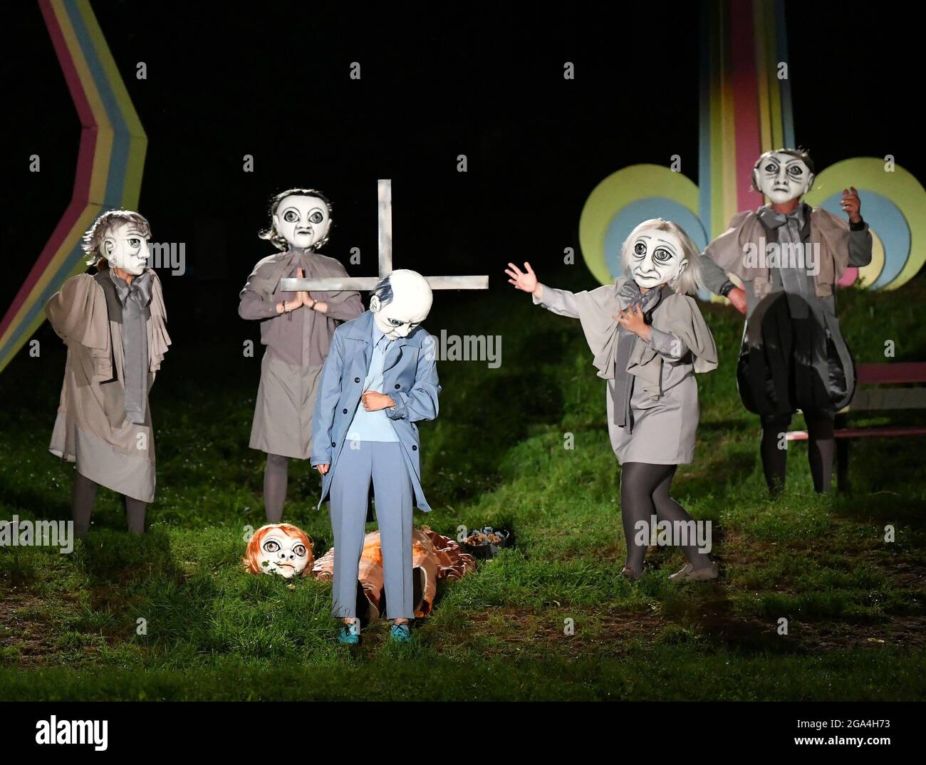 Netzeband, Germany. 27th July, 2021. With masks the actors play at the photo rehearsal of the play 'Frühlings Erwachen' at the Naturbühne Nützeband. The play by F. Wedekind is directed by F. Matthus and has its premiere on July 30. Netzeband shows ''Spring Awakening'' in the special aesthetics of synchronous theatre - as a play with masks to a pre-produced audio installation. Credit: Bernd Settnik/dpa/ZB/dpa/Alamy Live News Stock Photo