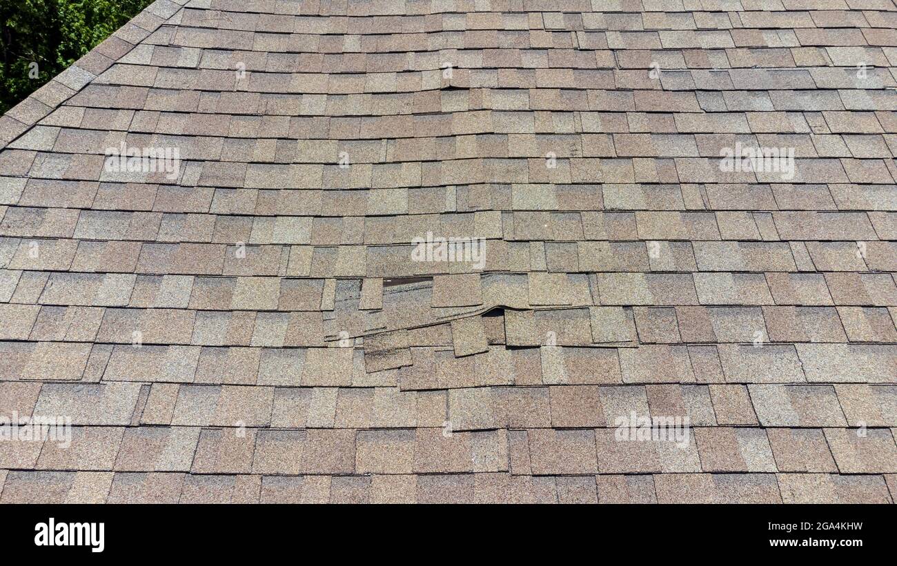 Roof Shingles damaged and in need of repair Stock Photo