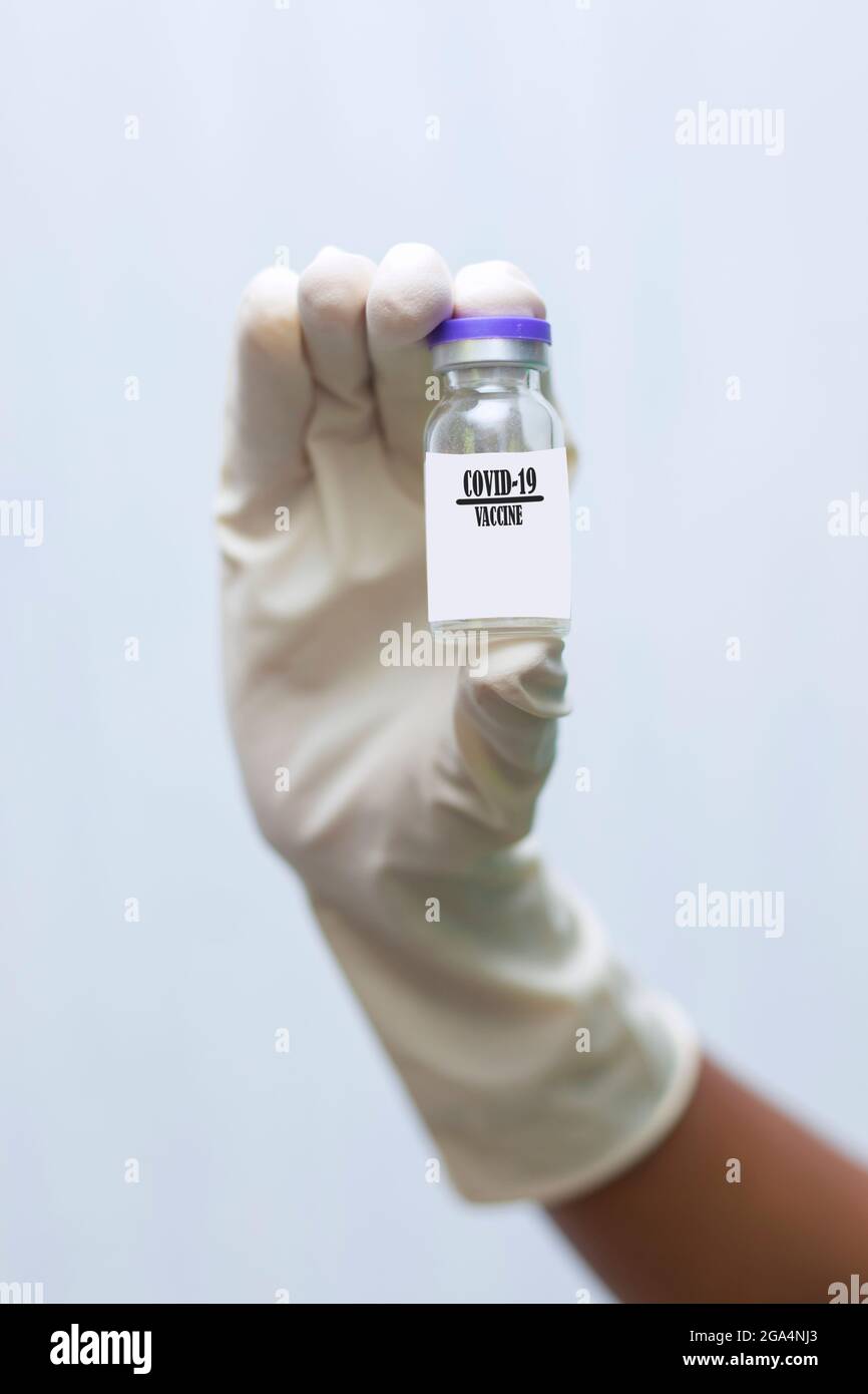a doctor holding covid-19 vaccine with syringe Stock Photo