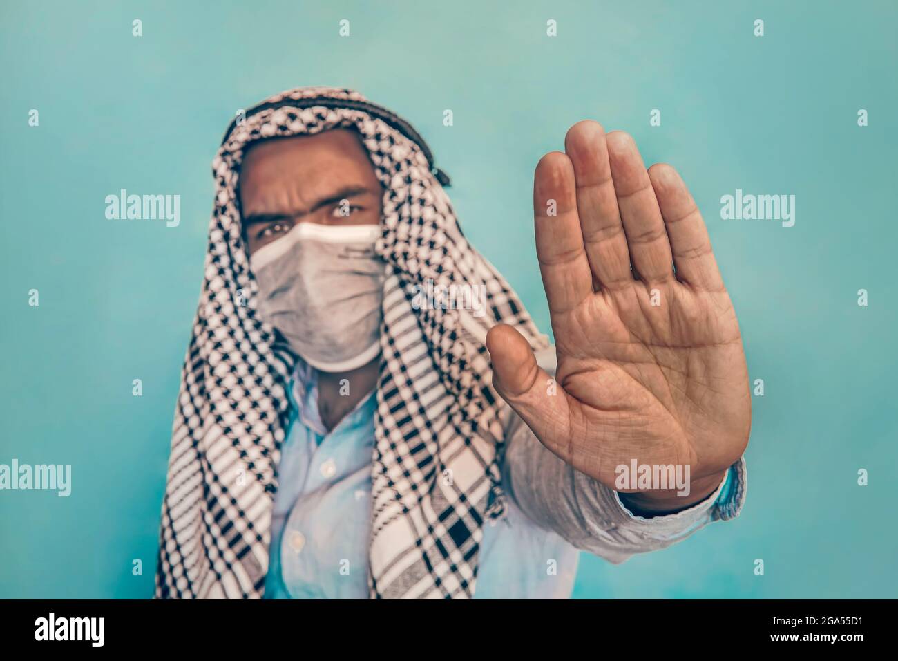 Arab man with face medical mask showing stop gesture. People, healthcare  and medicine concept. entrance without a mask is prohibited Stock Photo -  Alamy