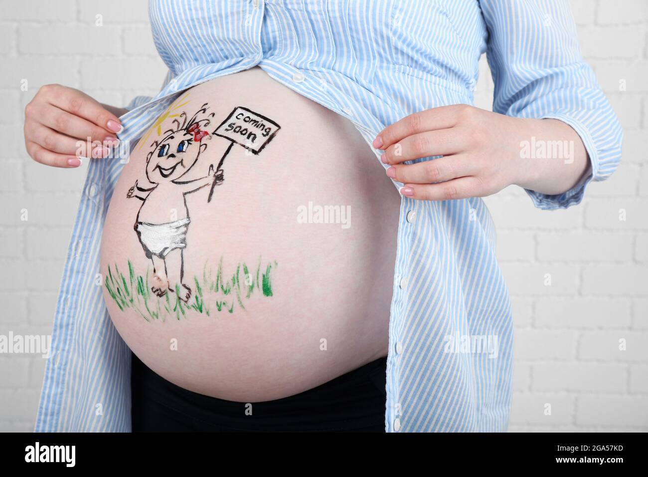 Body art on belly of pregnant woman on light background Stock Photo - Alamy