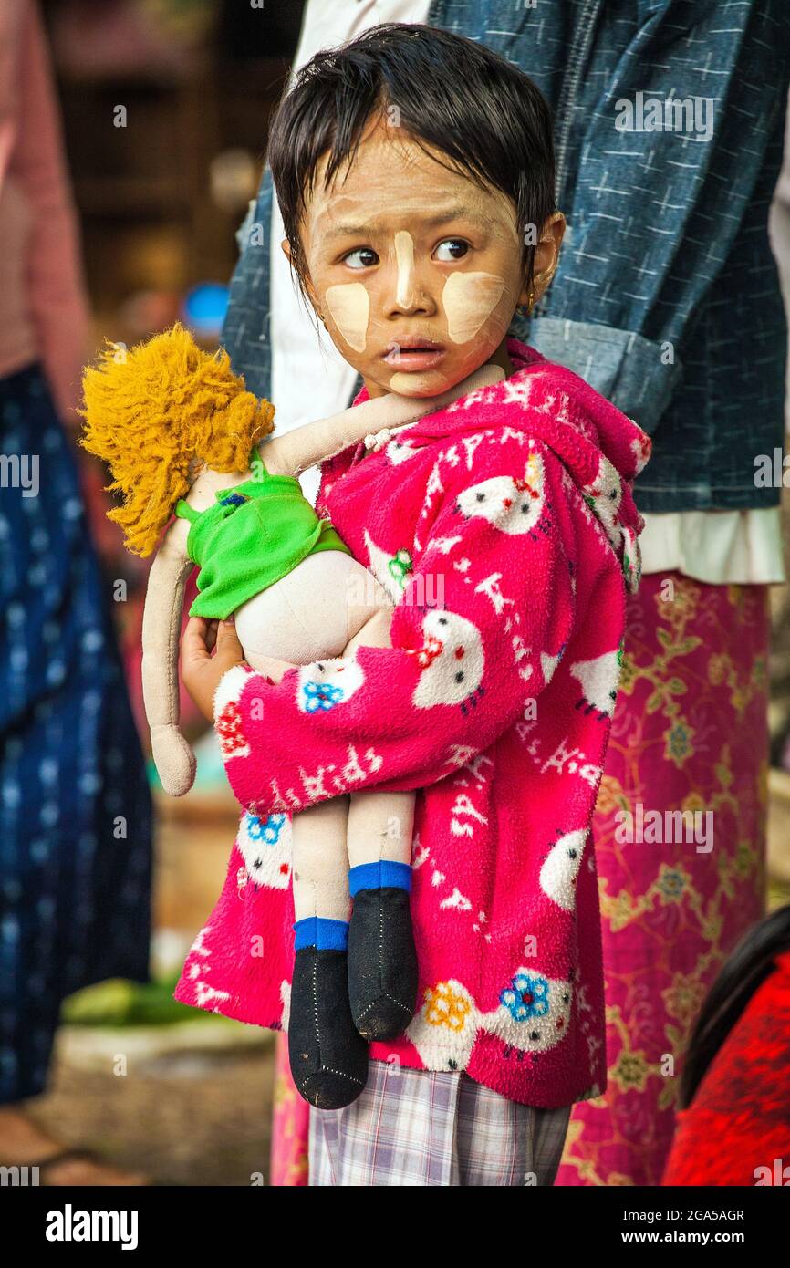 Carry A Rag Cute Burmese child with thanaka face powder carrying rag doll, Hsipaw ...