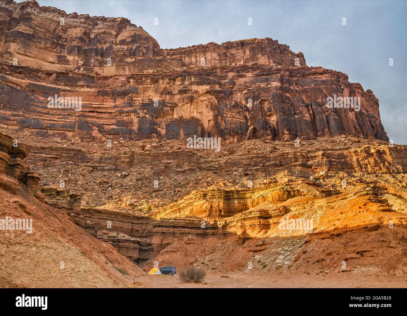 Secluded campsite under cliffs near Mexican Mountain Road and San Rafael River, at sunset, near Buckhorn Wash, San Rafael Swell area, Utah, USA Stock Photo