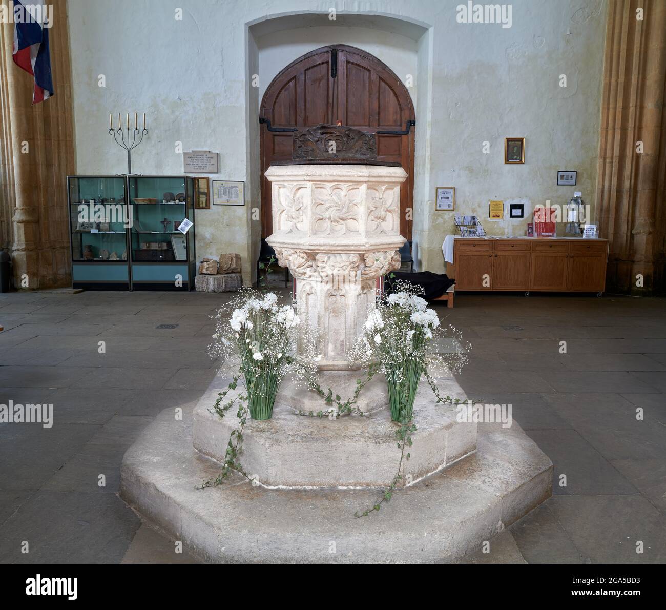 The fifteenth century stone baptismal font in the medieval christian church of St Mary and All Saints at the village of Fotheringhay, England. Stock Photo