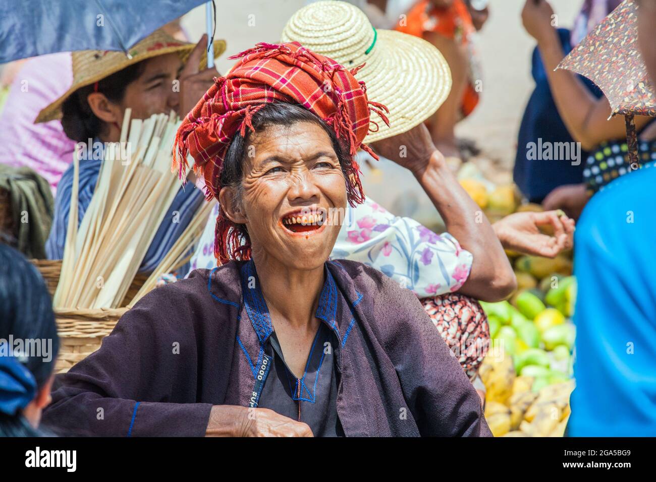 Female from Pa'o (Pa-o) ethnic hill tribe wearing red turban with betel nut stains on teeth in Kalaw, Shan State, Myanmar Stock Photo