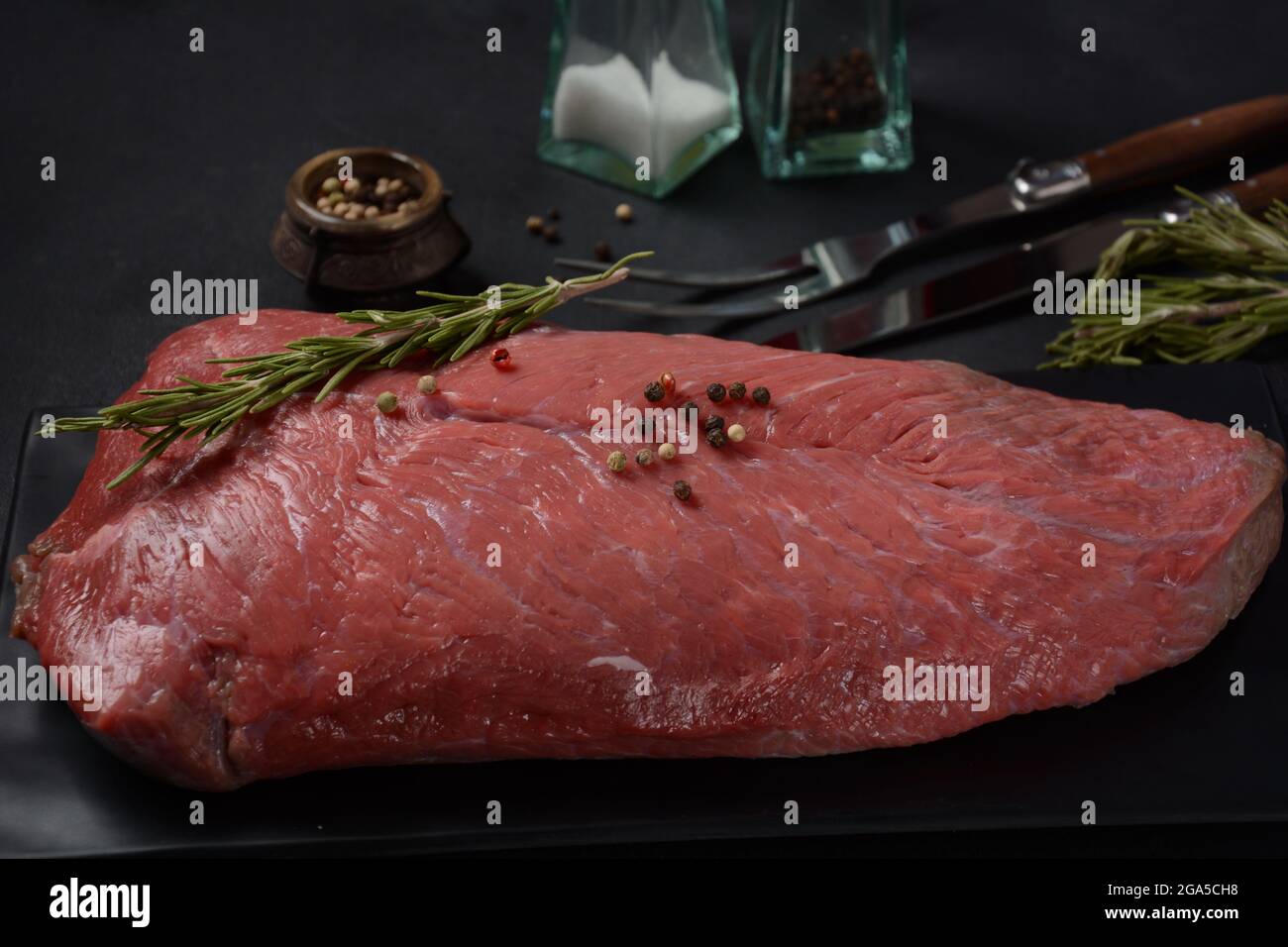 Raw beef meat. Whole piece of tenderloin with rosemary ready to cook on ...
