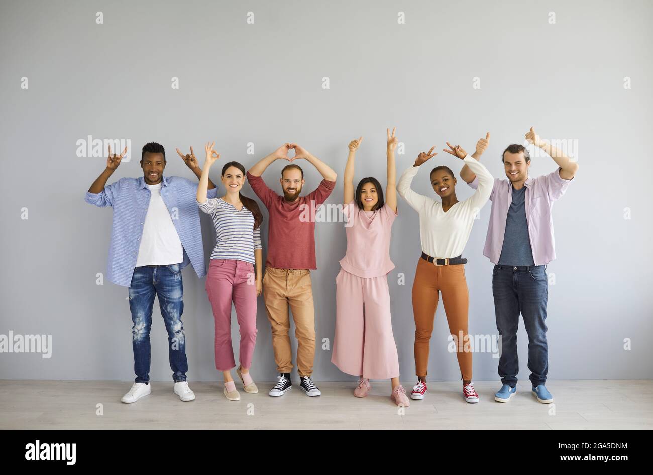 Group of happy multiracial people showing positive hand gestures like OK, thumbs up, etc Stock Photo