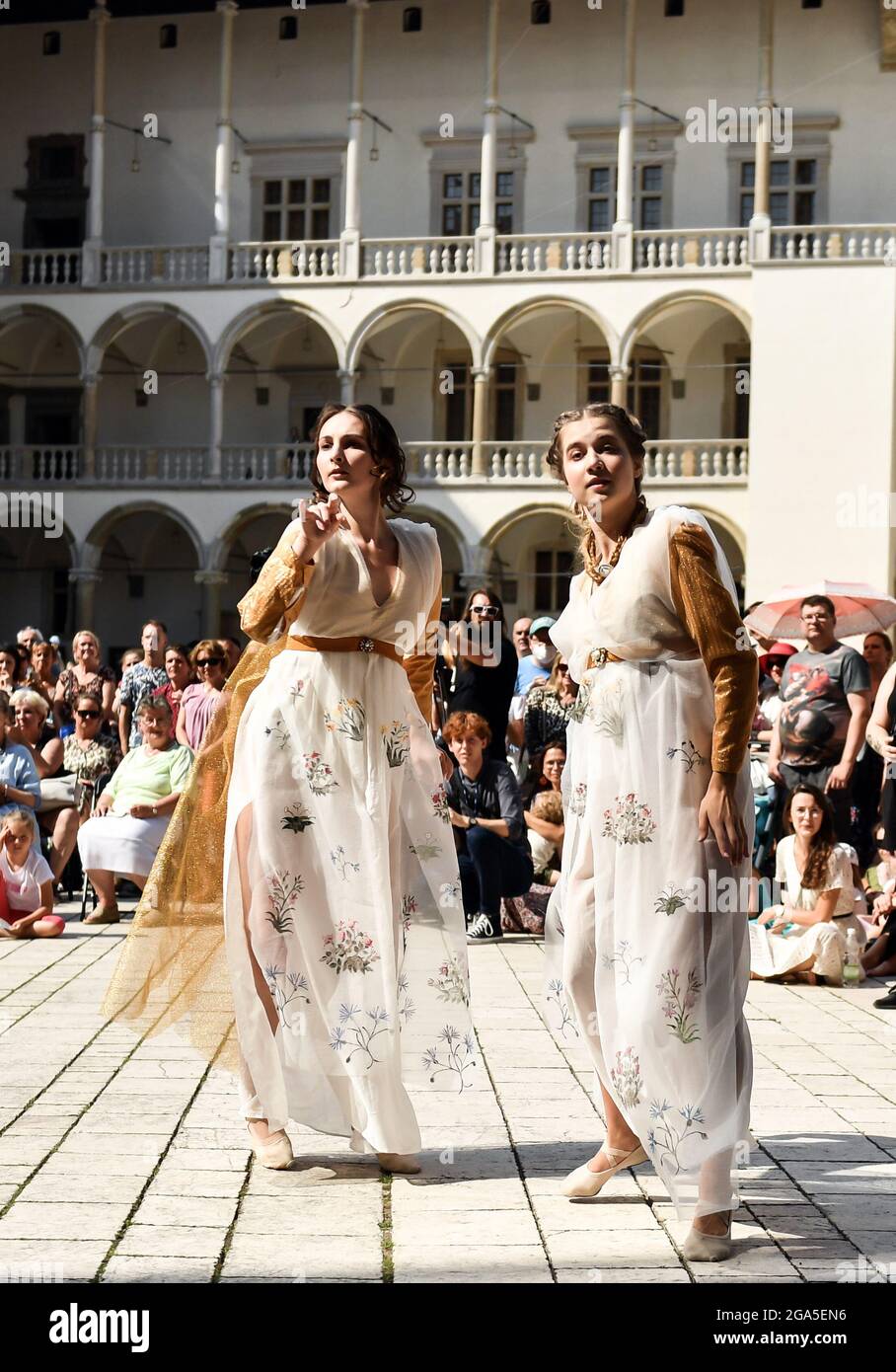 Performers dancing on stage during the fashion show.Dancers from the Terpsichore Dance Theatre and actors from Nomina Rosae Teatr presented a reconstruction of Renaissance fashion in the courtyard of the Wawel Royal Castle in Krakow. Stock Photo