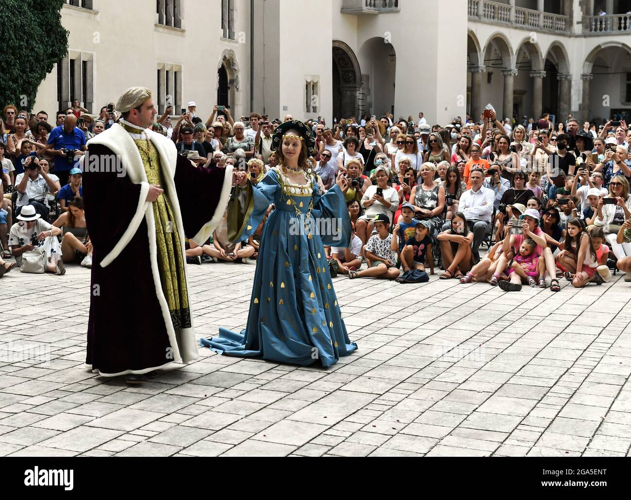 Performers dancing on stage during the fashion show.Dancers from the Terpsichore Dance Theatre and actors from Nomina Rosae Teatr presented a reconstruction of Renaissance fashion in the courtyard of the Wawel Royal Castle in Krakow. Stock Photo