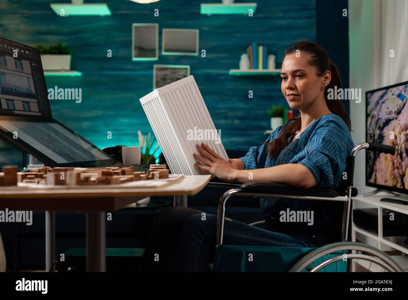 Disabled engineer sitting in wheelchair with maquette building icon ...