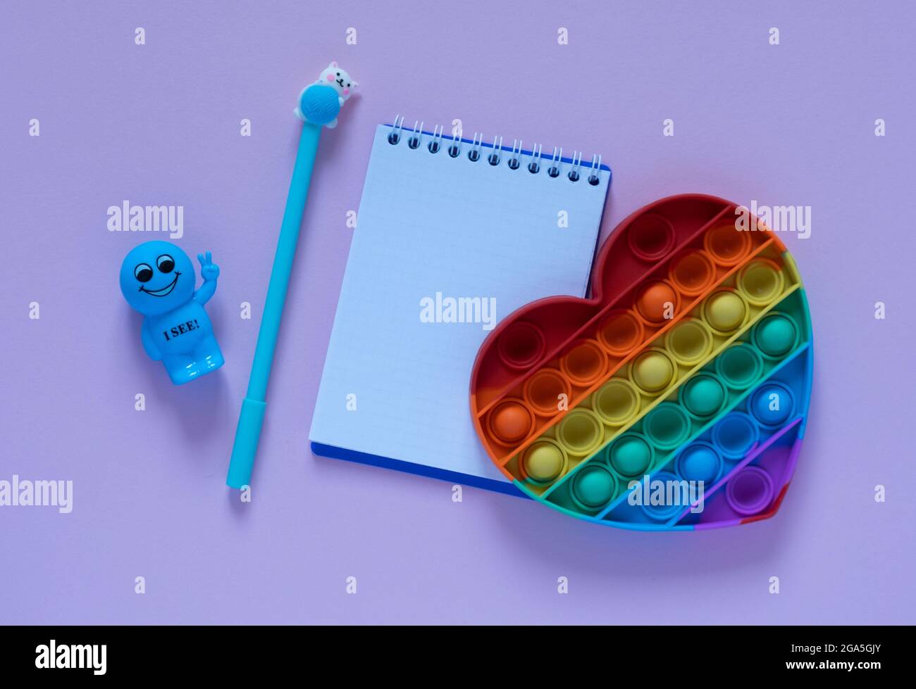 Back to school concept.Notepad, blue pen and antistress toy in the form ...