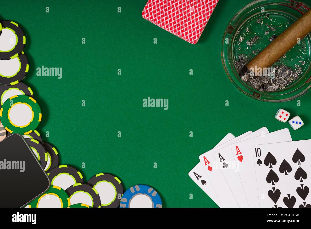 different color chips for gamblings and playing cards on green Stock