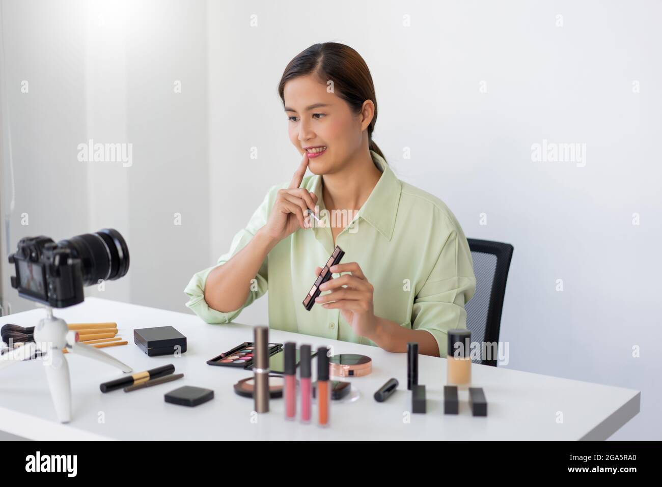 A female beauty blogger reviewing quality of the colorful eyeshadow ...