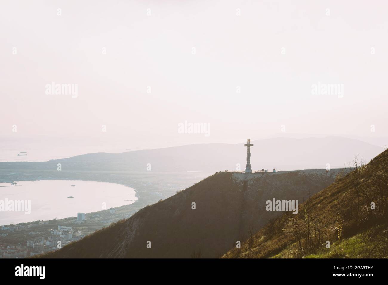 Orthodox cross on Markotkh ridge at sunset. Stock Photo