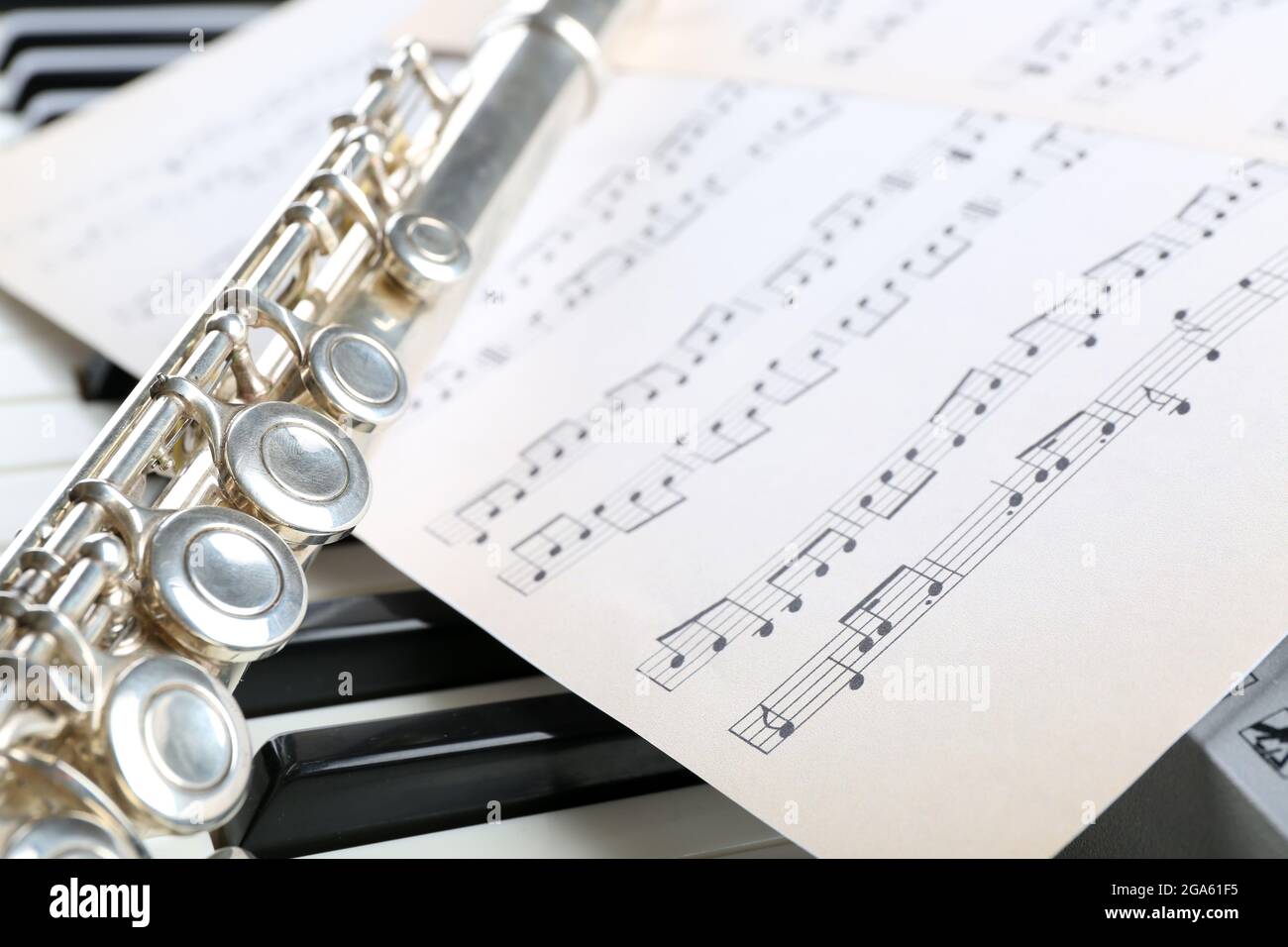 Flute and piano with music sheet close up Stock Photo - Alamy